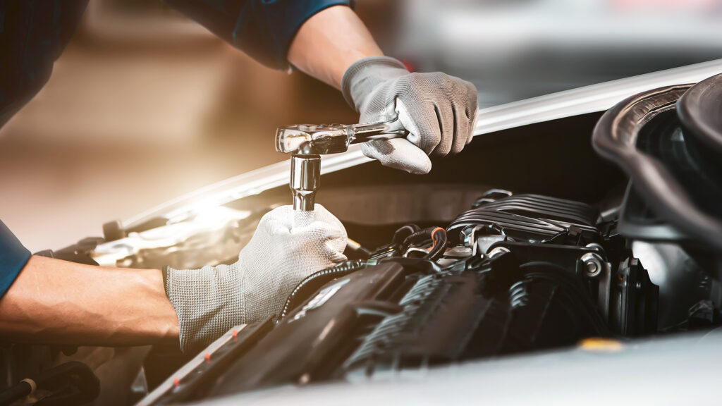 Technician repairing car